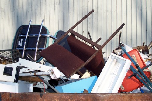 Workers sorting garden waste and recyclables at a local site