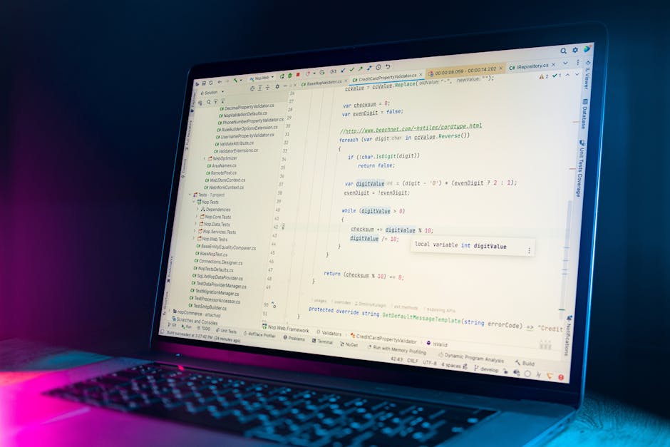 A close-up view of a laptop screen displaying lines of computer programming code in a text editor. The code includes various functions, comments, and syntax elements, with some highlighted in differen